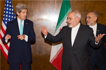 Secretary of State John Kerry discusses seating arrangements for a meeting with Iranian Foreign Minister Mohammad Javad Zarif during a round of...