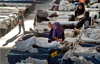 Migrants rest in a shelter in Hanau, Germany, on Thursday. AP