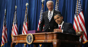President Obama signs the stimulus package as Vice President Joe Biden looks on. AP photo
