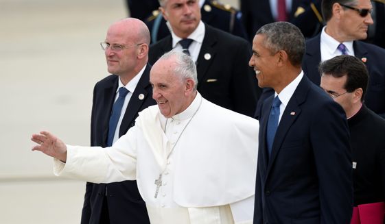 Pope Francis, center, walks with President Barack Obama, right, after arriving at Andrews Air Force Base in Md., Tuesday, Sept. 22, 2015. The Pope is spending three days in Washington before heading to New York and Philadelphia. This is the Pope's first visit to the United States. (AP Photo/Susan Walsh)